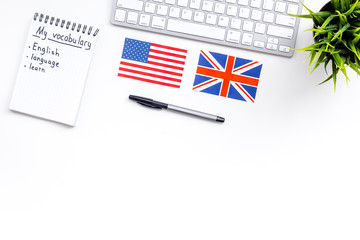 Learn english concept. British and american flags, computer keyboard, notebook for new vocabulary...