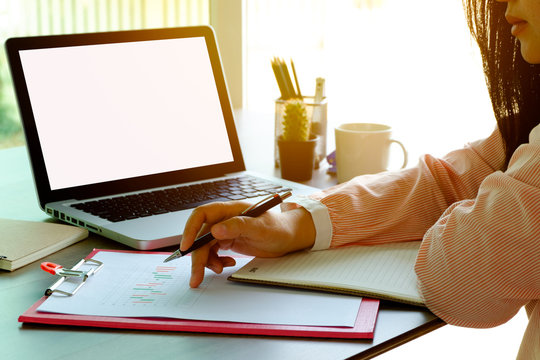 women working laptop and on the white table at cafe and home office. in morning light