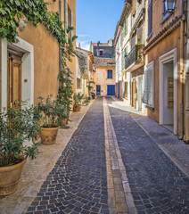Fototapeta na wymiar Charming, stone street of colorful, old homes in Southern France