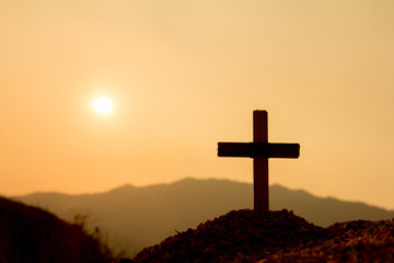 The cross on the mountain has the sunset as the background., Concept for Christian, Christianity, Catholic religion, divine, heavenly, celestial or god.