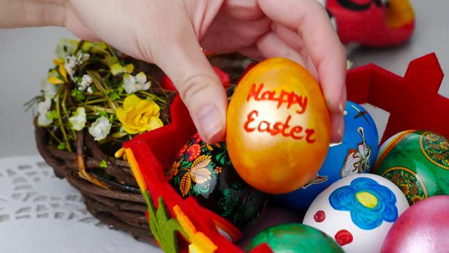 Happy easter felicitation. Colorful eggs in a bascket