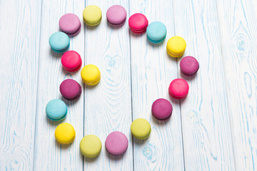 Bright almond cookies laid out on a light wooden background in the form of heart