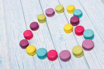 Bright almond cookies laid out on a light wooden background in the form of heart