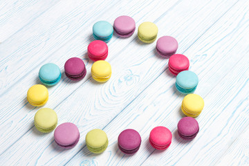 Bright almond cookies laid out on a light wooden background in the form of heart