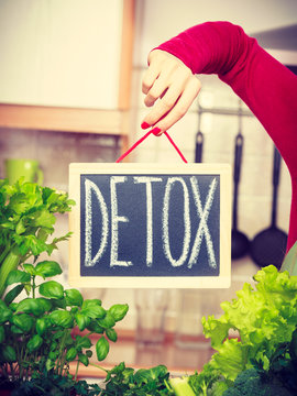 Woman having green diet vegetables, detox sign