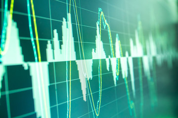 Stock market graph analysis. Stock market data on LED display on laptop screen for finance and...