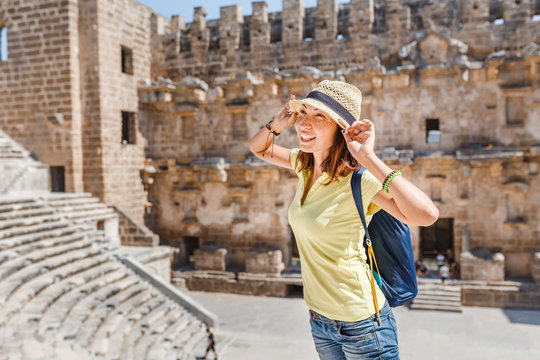 Woman tourist on excursion in ancient Greek theater, history and travel concept