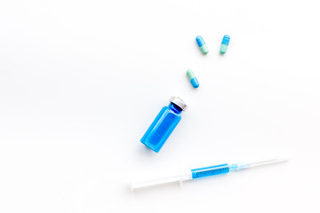 Syringe with medicine. Injection concept on white baclground top view copy space