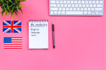Learn english concept. British and american flags, computer keyboard, headphones, notebook for new...
