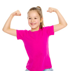 A little girl shows her muscles.