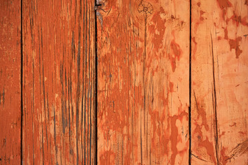 Old wooden background painted in red with cracks.