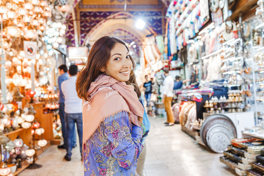 Woman tourist walking among countless shops in Grand Bazaar market in Istanbul. Shopping and travel in Turkey concept