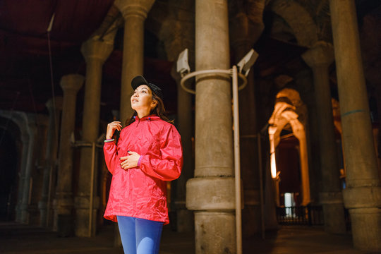 Woman tourist in ancient underground travel destination, storage of fresh water Yerebatan Saray or Cistern Basilica