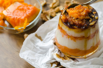 Layered pumpkin dessert with cream and walnut, grape juice