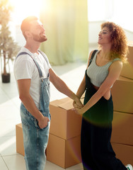 loving young couple standing in a new apartment