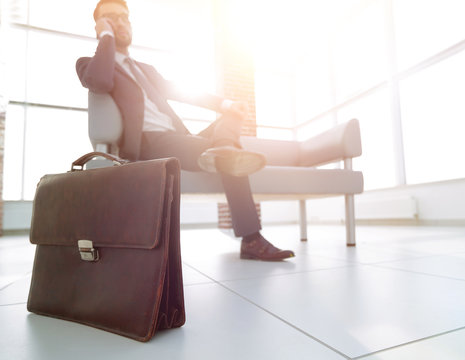 Businessman Holding His Briefcase In Office