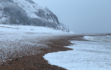 Snow on the beach near town of Seaton in Devon on the Jurassic Coast