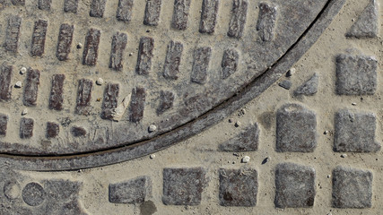 The texture of the sewer hatch
