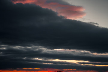 A beautiful sunset on the embankment of the city of Khabarovsk with beautiful textured images and a bloody sun