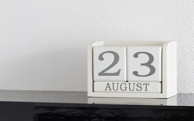 White block calendar present date 23 and month August