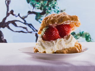 Delicious dessert puff with strawberry and whipped cream. Summer is coming! Sweet dreams.