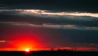 A beautiful sunset on the embankment of the city of Khabarovsk with beautiful textured images and a bloody sun