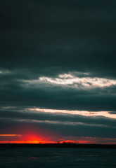 A beautiful sunset on the embankment of the city of Khabarovsk with beautiful textured images and a bloody sun