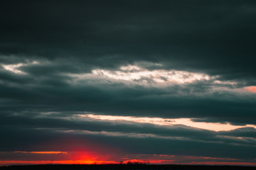 A beautiful sunset on the embankment of the city of Khabarovsk with beautiful textured images and a bloody sun