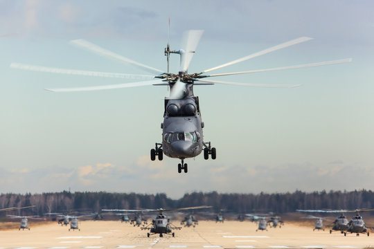 View from the end of a runway on rise of group of helicopters
