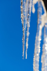 Icicle against the blue sky in winter