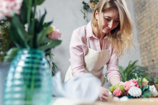 Photo of florist making bouquet at table