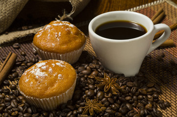White cup of coffee with cake and cinnamon