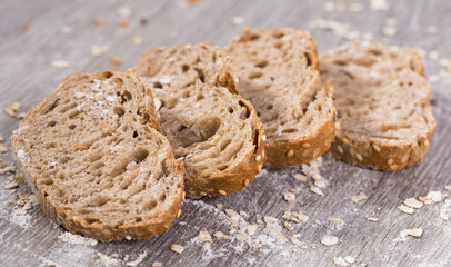 fresh slices of rye bread on wooden surface
