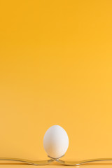 egg white subject with forks on yellow background and text field
