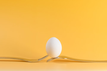 egg white subject with forks on yellow background and text field