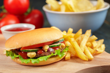 Fast food, homemade burger on a wooden background