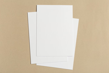 White business card on wooden table. Blank portrait A4.