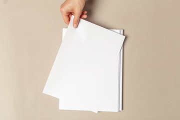 Hand holding papers a4 size