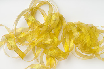 Shiny golden ribbon winded in spiral pattern on white background. Backdrop for text or announcement