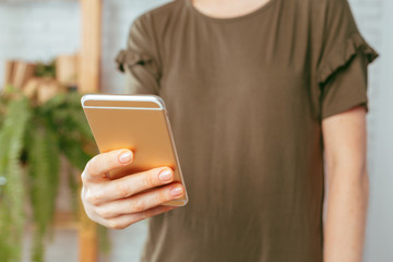 close up of woman texting on smartphone