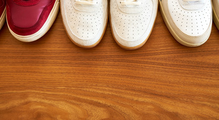 Top View Of Three Pair Of Red And White Sneaker Shoes On A Wooden Surface Top View