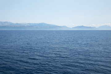 Deep blue ocean and distant land