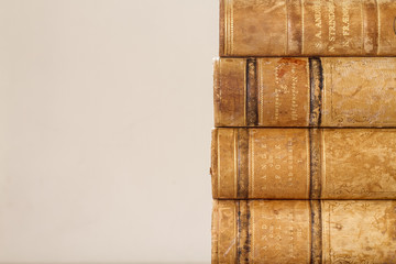 Close up of old books with weathered leather backs