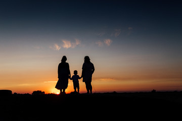 Fototapeta na wymiar Three members of the family watching sunset