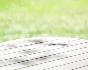 Round wood table top on green background