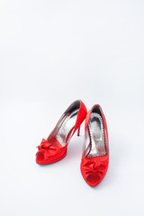 red female shoes with a bow on a white background 