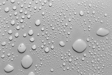 Surface with water drops, grey background