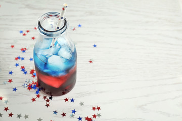 Layered cocktail in colors of American flag on table