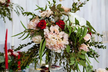  bright bouquet of flowers in a vase stands on a festively decorated wedding table