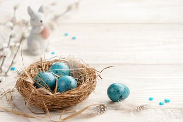 Easter background with Easter eggs and spring flowers. Top view with copy space.